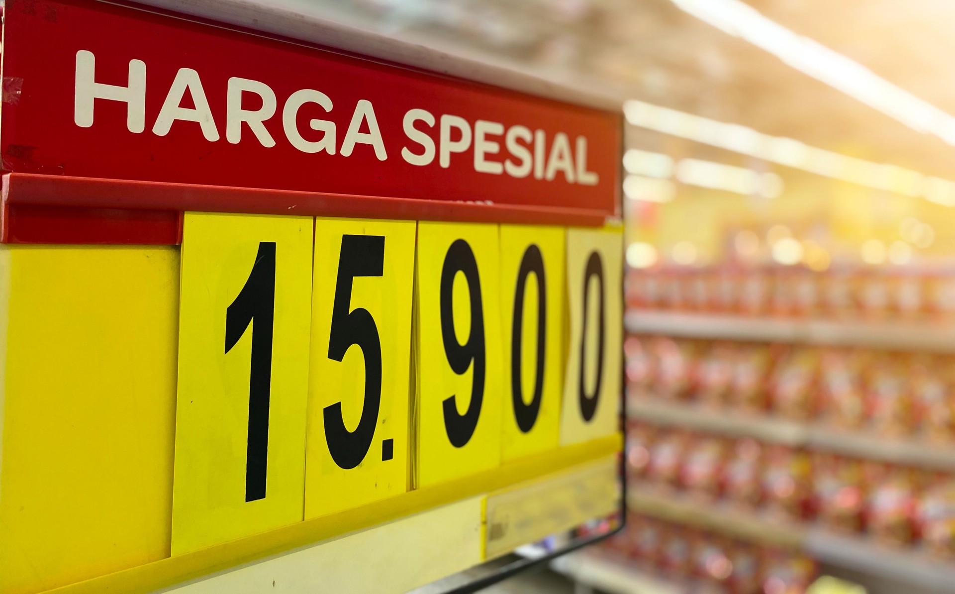 Close-up captures a special price tag in a shop aisle with blurred background.
